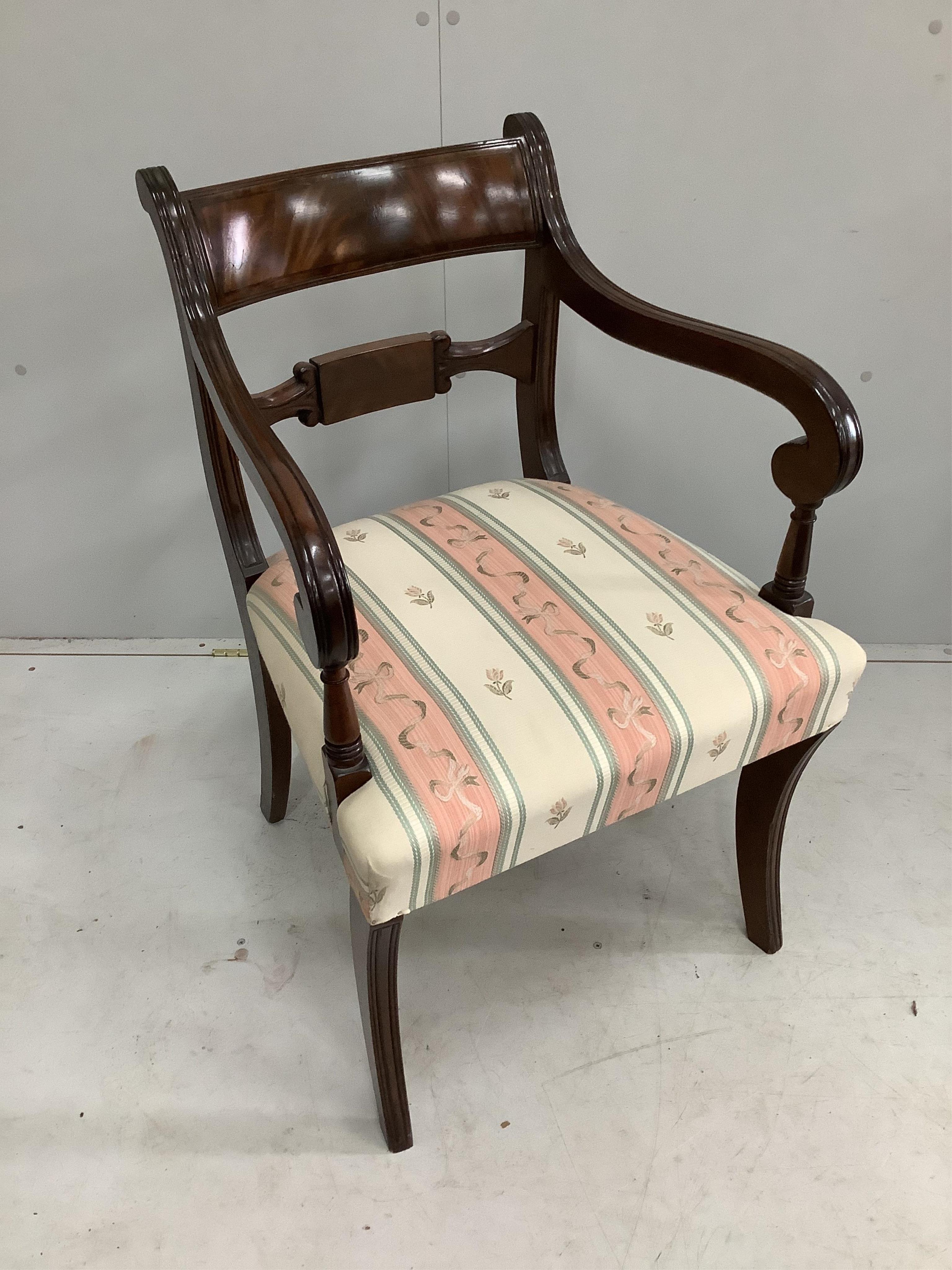 A set of eight reproduction Regency style mahogany sabre leg dining chairs, two with arms